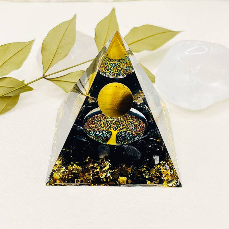 Decorative pyramid with tree of life and moon design on a white background