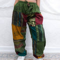 Colorful patchwork pants with intricate patterns on a white background