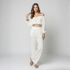 Woman wearing a white outfit on a plain background