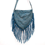 Blue suede handbag with fringe details on a white background
