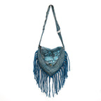 Blue fringed handbag with floral embroidery on a white background