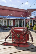 Close-Up Burgundy Bag on Marketplace Table