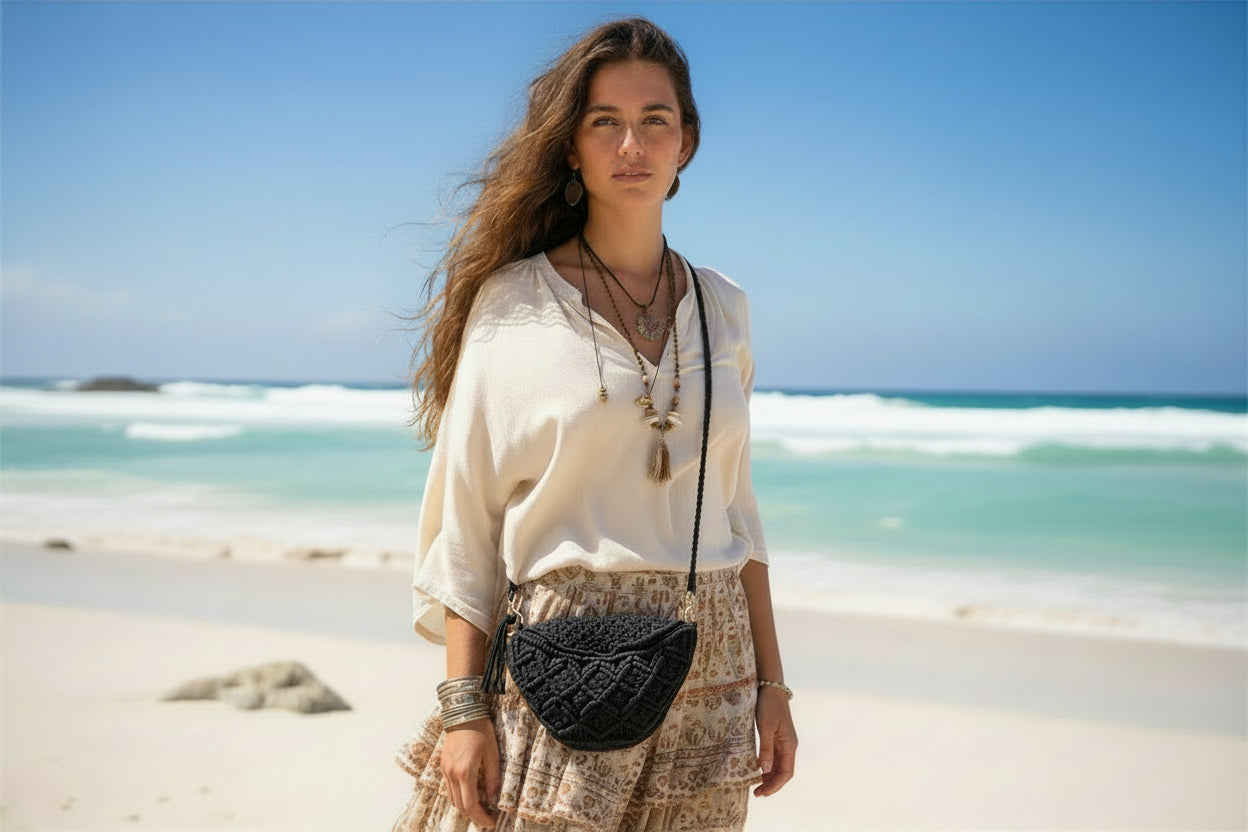 Black woven handbag with a strap on a light gray background